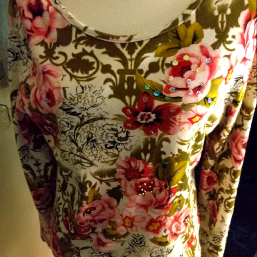 Used,not new long sleeve cotton knit floral top. Has scattered sequins,gold bead